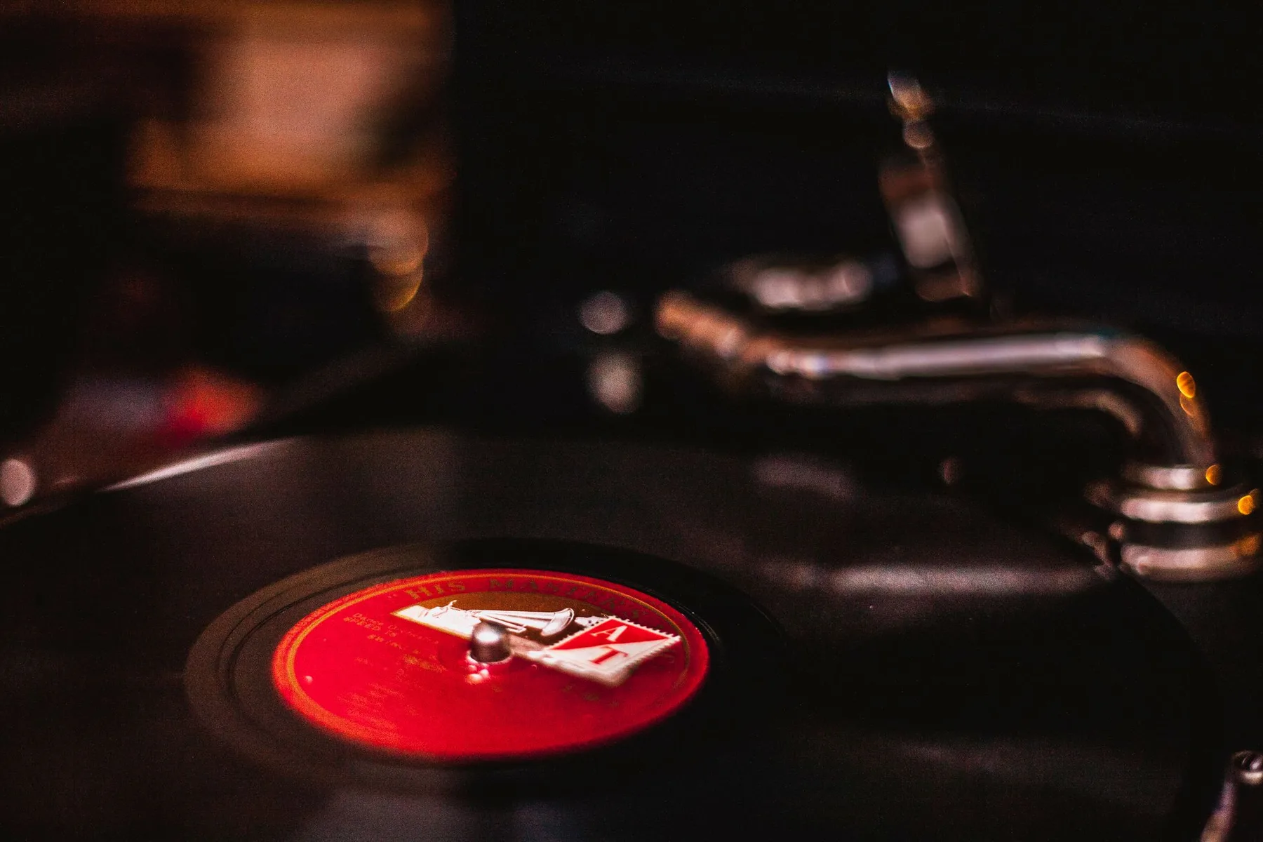 Close-up of a vintage turntable playing a vinyl record, capturing the nostalgic feel of analogue music mediums.