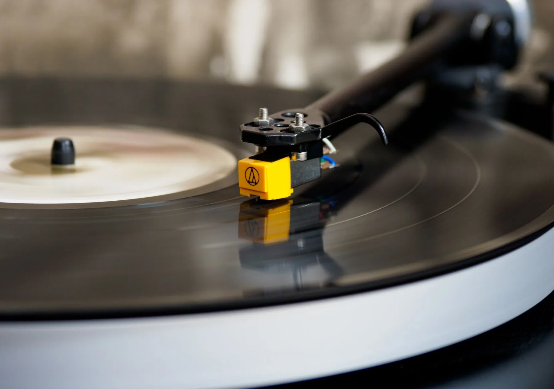 High-resolution image of a spinning vinyl record on a turntable, capturing the classic audio experience.